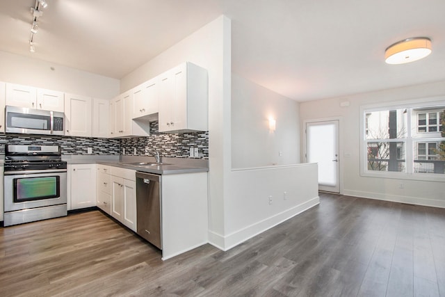 kitchen featuring stainless steel appliances, dark hardwood / wood-style floors, and white cabinets