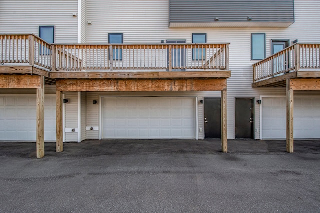 exterior space with a garage and a wooden deck