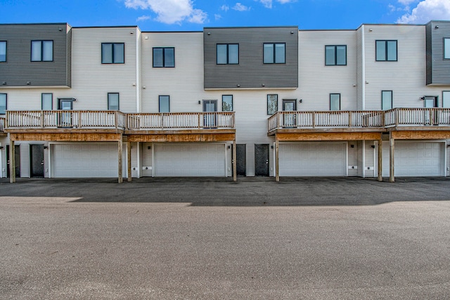 back of house with a balcony and a garage