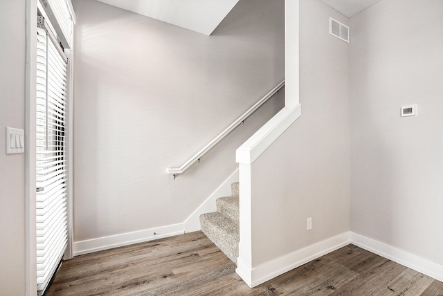 stairway featuring hardwood / wood-style flooring