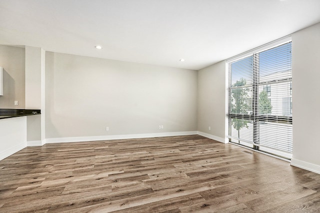 unfurnished room with wood-type flooring