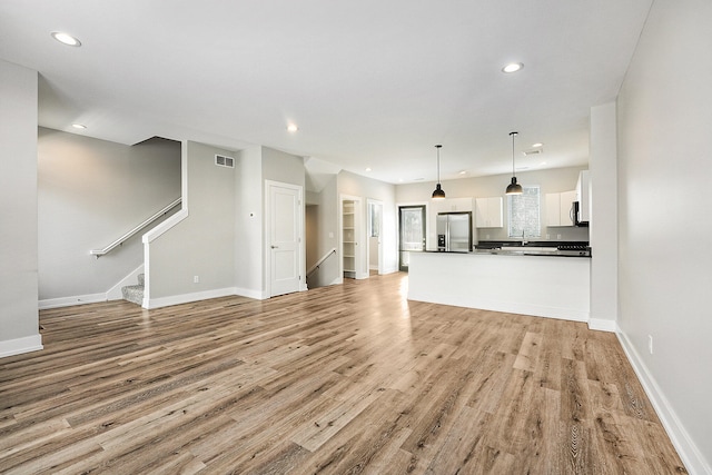 unfurnished living room with light hardwood / wood-style flooring