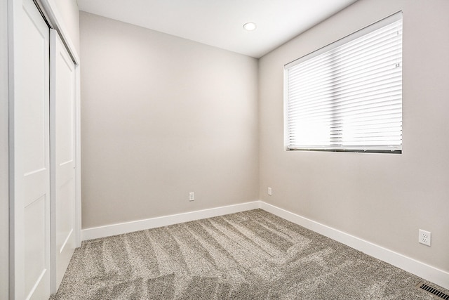 unfurnished bedroom with a closet and carpet