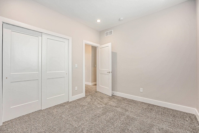 unfurnished bedroom with a closet and carpet