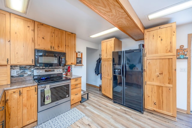 kitchen featuring decorative backsplash, black appliances, and light hardwood / wood-style floors