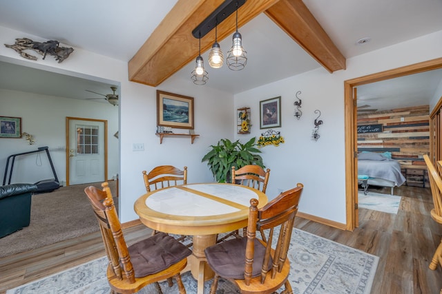 dining room with hardwood / wood-style floors, beam ceiling, and ceiling fan