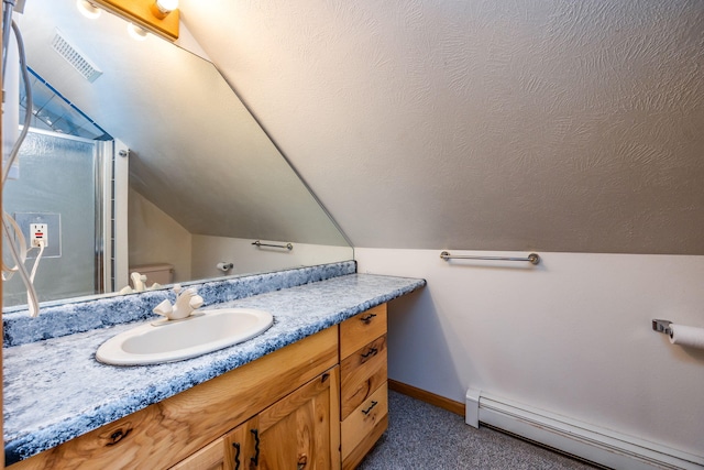 bathroom featuring lofted ceiling, toilet, a textured ceiling, vanity, and a baseboard heating unit