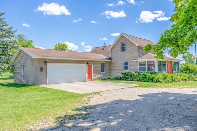 view of front property featuring a garage and a front yard