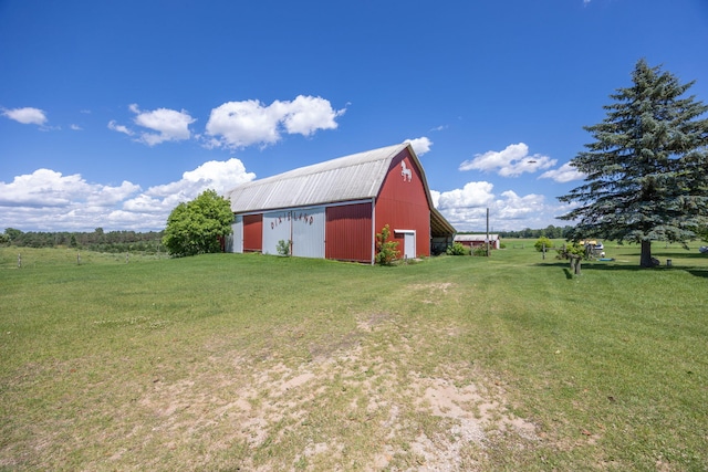 view of outbuilding with a yard and a rural view