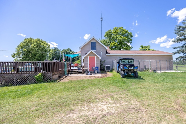 back of house with a wooden deck, a lawn, and central air condition unit