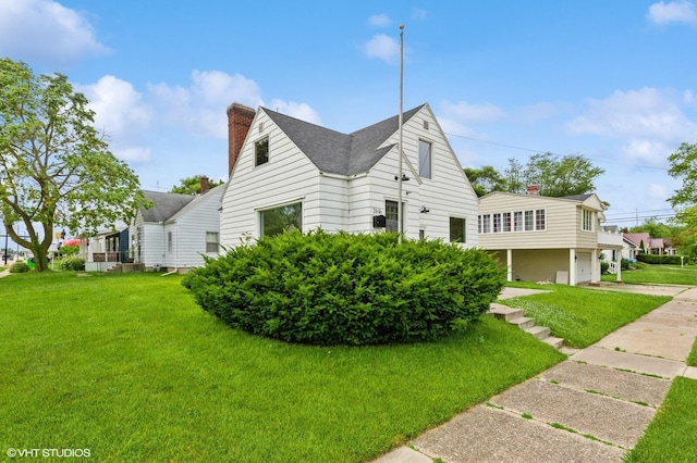 view of side of home with a garage and a lawn