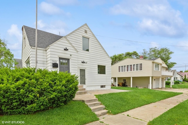 view of front of house with a garage and a front lawn