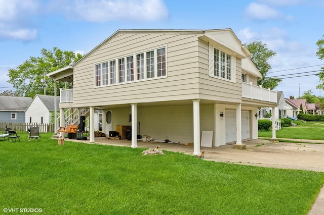 exterior space with a garage, a lawn, and a balcony