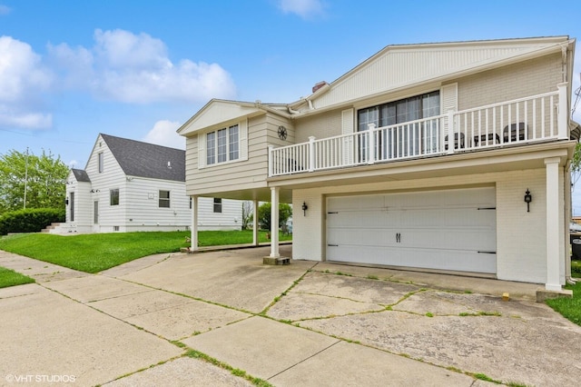 view of front facade with a garage, a front lawn, and a balcony