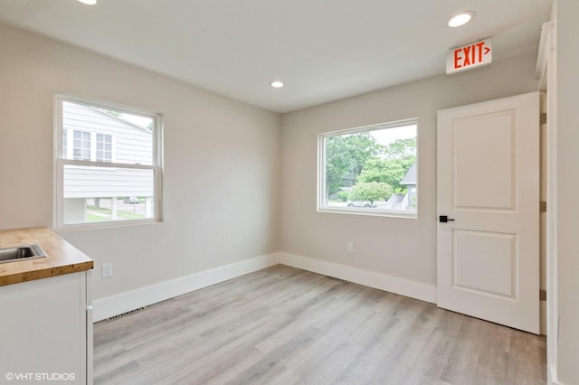 spare room featuring light hardwood / wood-style flooring