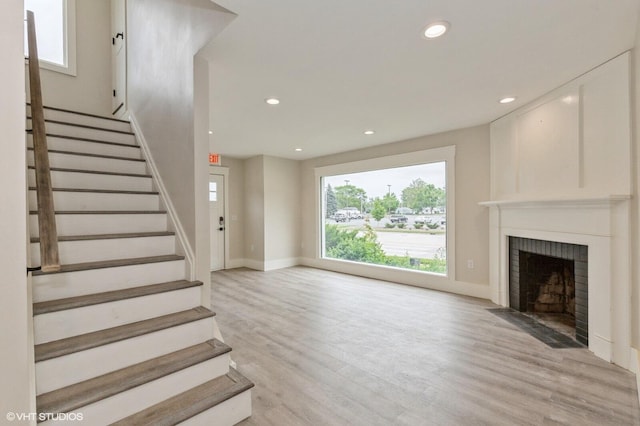 interior space with a fireplace and light hardwood / wood-style floors