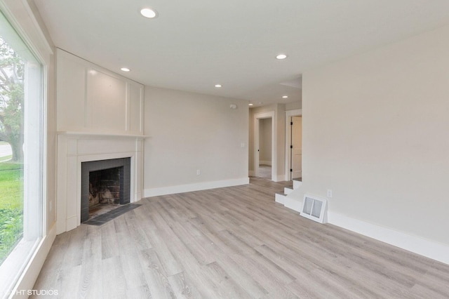 unfurnished living room featuring light hardwood / wood-style floors