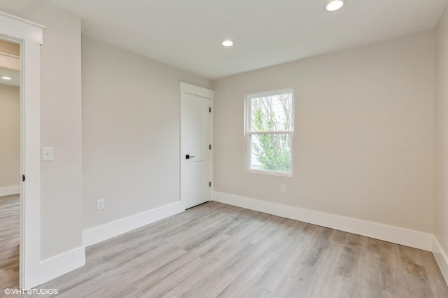 unfurnished room with light wood-type flooring