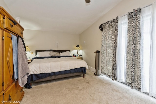 bedroom featuring light colored carpet and ceiling fan