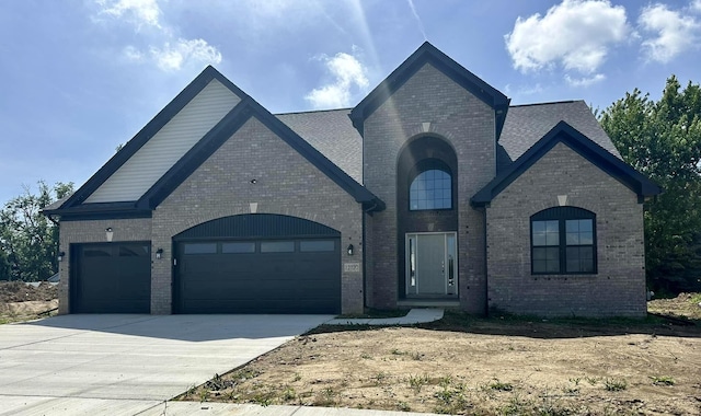 french country style house with a garage