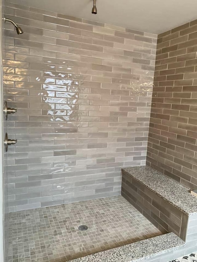 bathroom with a tile shower