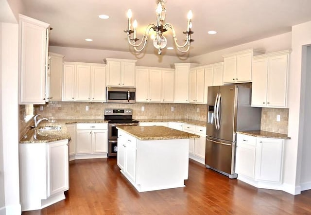 kitchen with sink, a center island, white cabinets, and appliances with stainless steel finishes