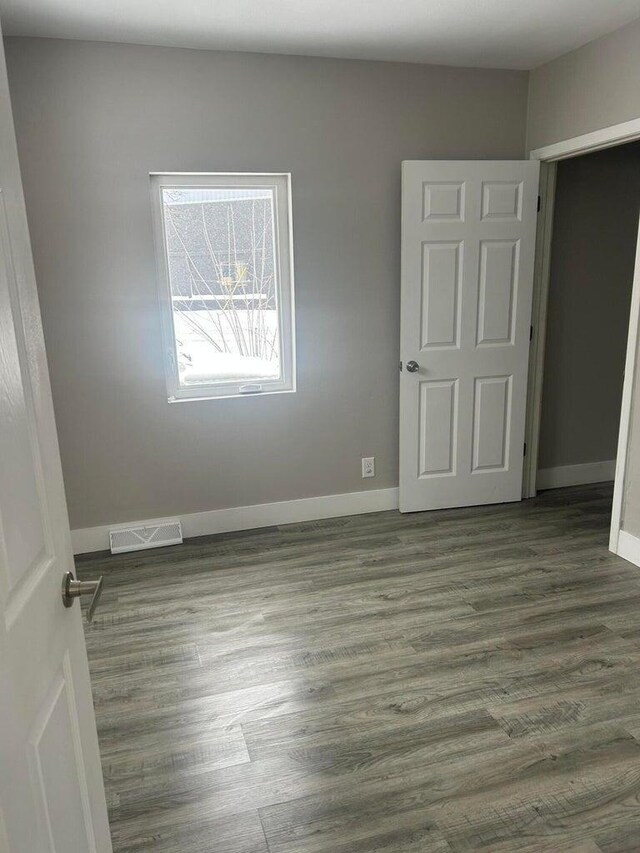 unfurnished room featuring dark hardwood / wood-style flooring