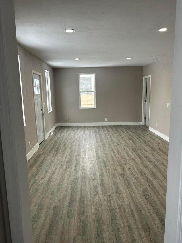 unfurnished room with dark hardwood / wood-style flooring