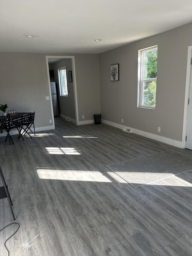 spare room with dark hardwood / wood-style floors