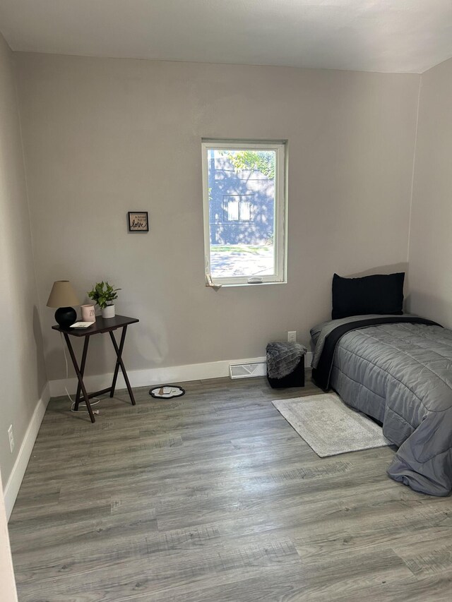 bedroom with hardwood / wood-style flooring