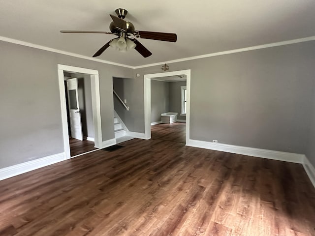 unfurnished bedroom with dark wood-type flooring, ceiling fan, connected bathroom, and crown molding