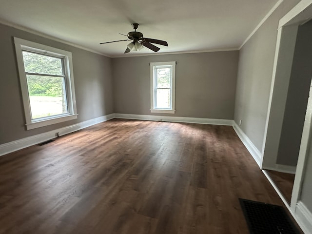 unfurnished room featuring dark wood-type flooring, ornamental molding, and ceiling fan