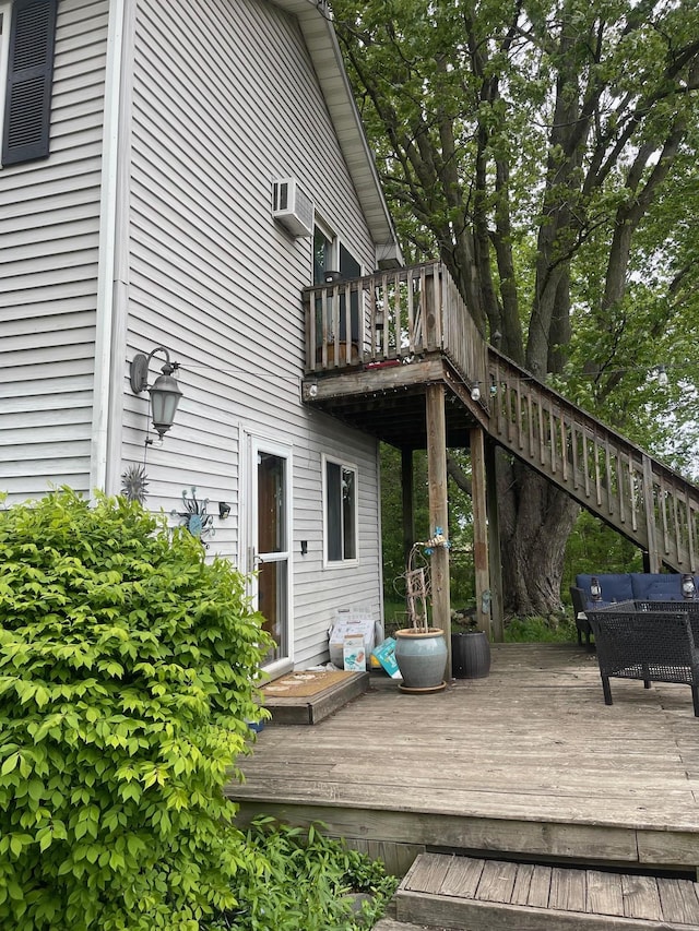 wooden deck featuring an outdoor hangout area and a wall mounted air conditioner