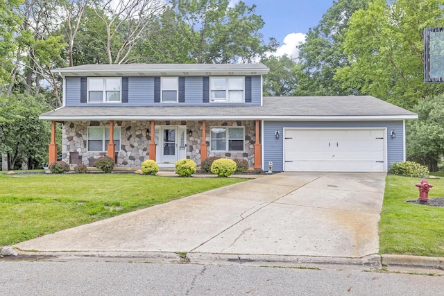 view of front facade featuring a porch, a garage, and a front yard