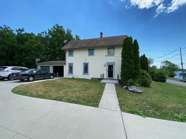 view of front of home featuring a garage and a front lawn