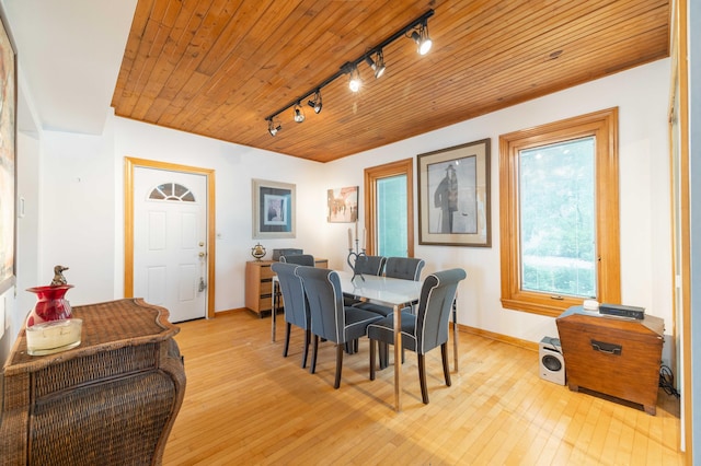 dining room featuring wood ceiling, a healthy amount of sunlight, and rail lighting