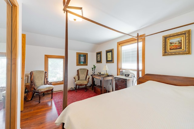 bedroom featuring vaulted ceiling and hardwood / wood-style floors