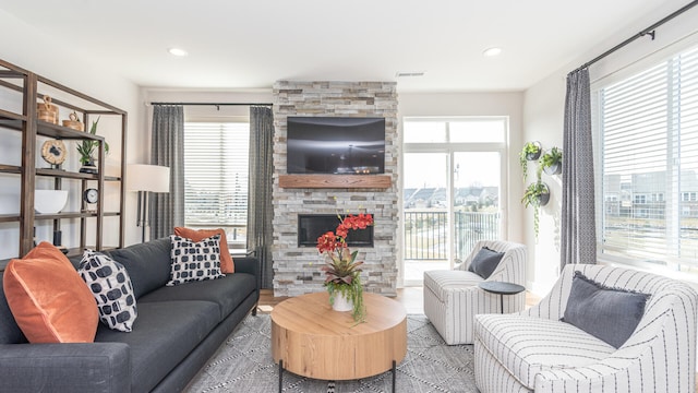 living room featuring a stone fireplace