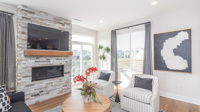 living room featuring hardwood / wood-style flooring and a fireplace