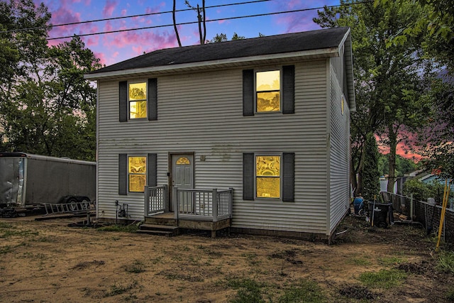 view of back house at dusk