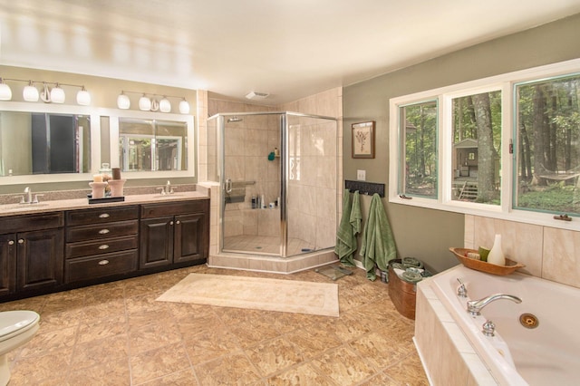 bathroom with vanity and separate shower and tub