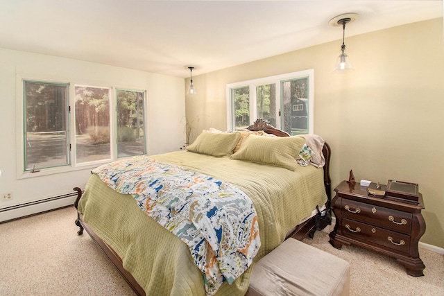 bedroom with a baseboard heating unit and light colored carpet