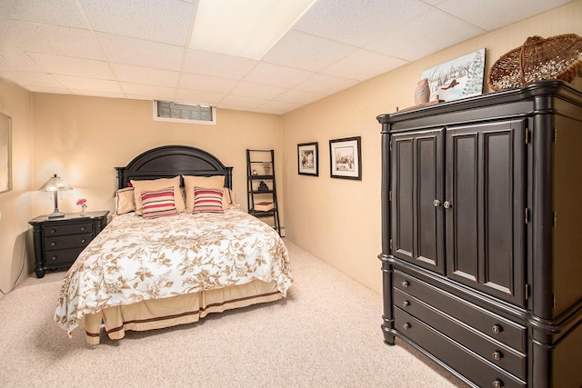 carpeted bedroom with a drop ceiling