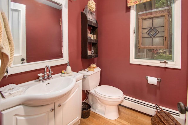 bathroom with vanity, a baseboard radiator, toilet, and wood-type flooring