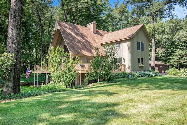 exterior space featuring a wooden deck and a lawn