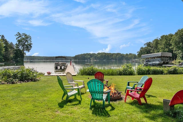 view of yard with a water view and a fire pit