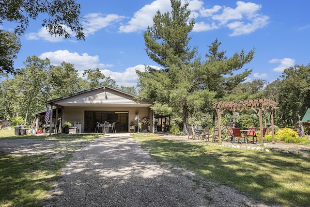 exterior space featuring a lawn and a pergola