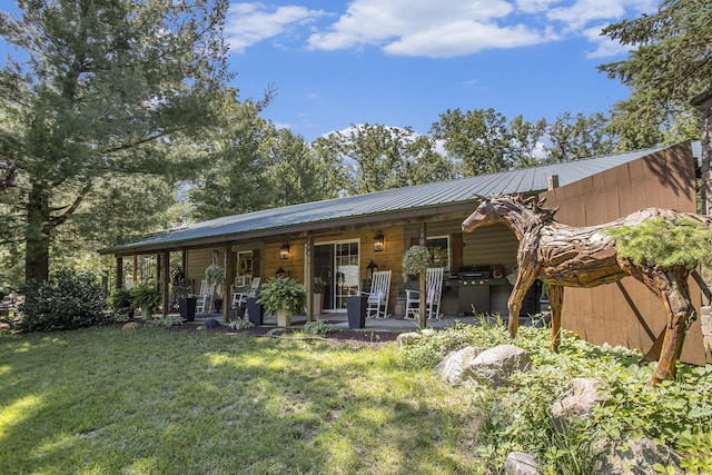 rear view of property featuring a yard and a patio