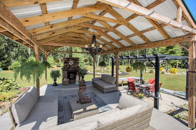 view of patio / terrace featuring a gazebo and an outdoor living space with a fireplace