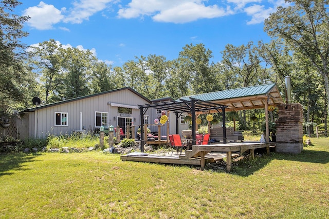 back of property with a wooden deck and a yard